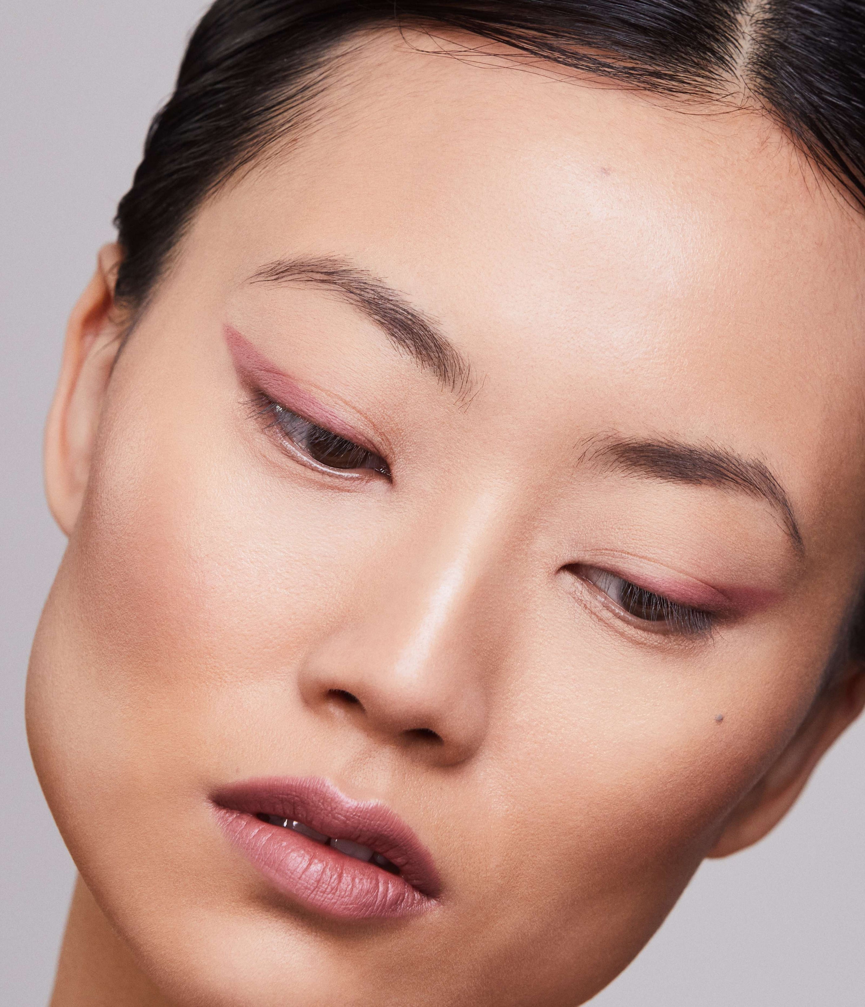 Close-up of a Model face wearing Aleph Eye/Lip Multi-Liner Blush