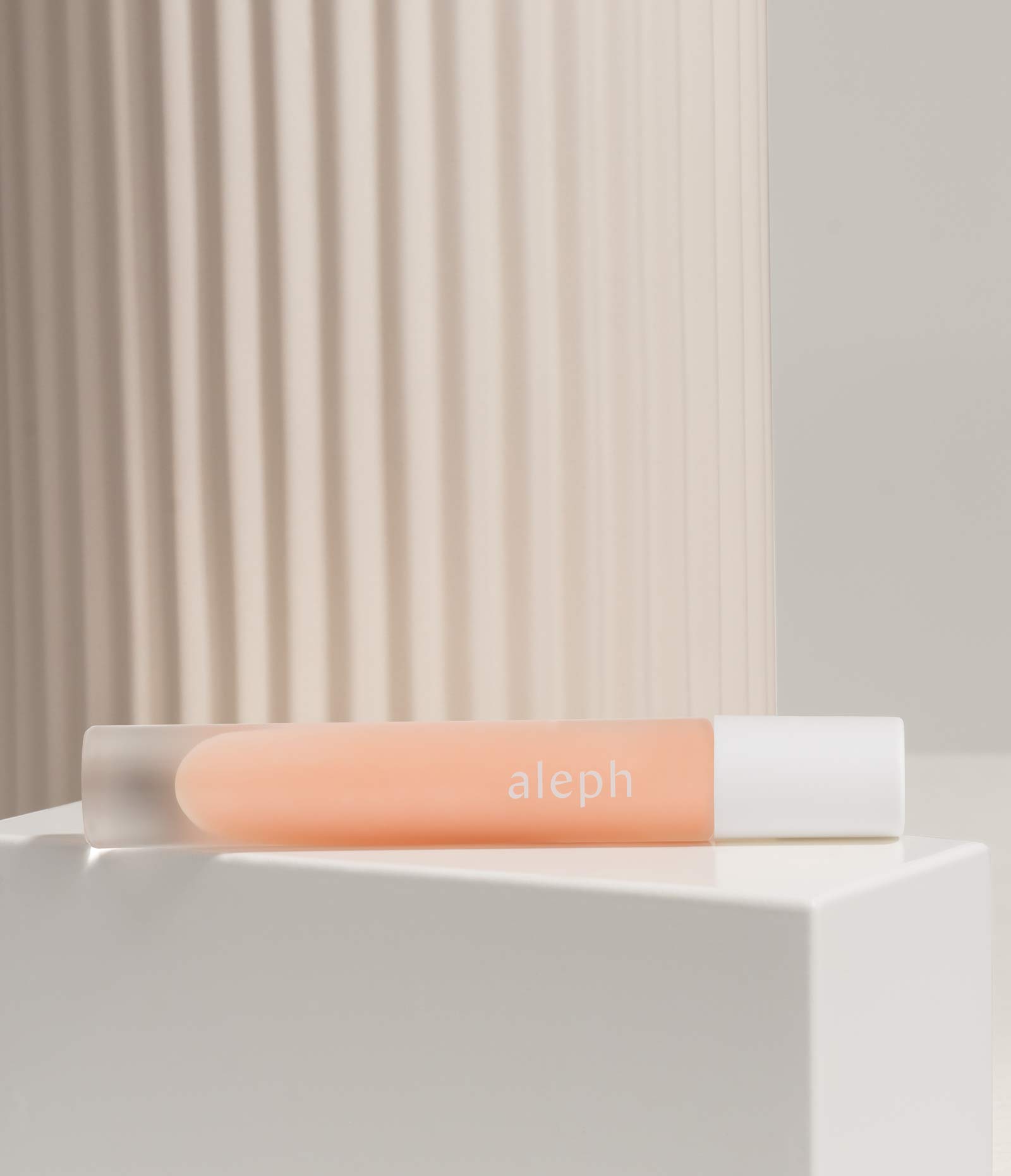 Styled image of Aleph Lucid Lipgloss on shelf
